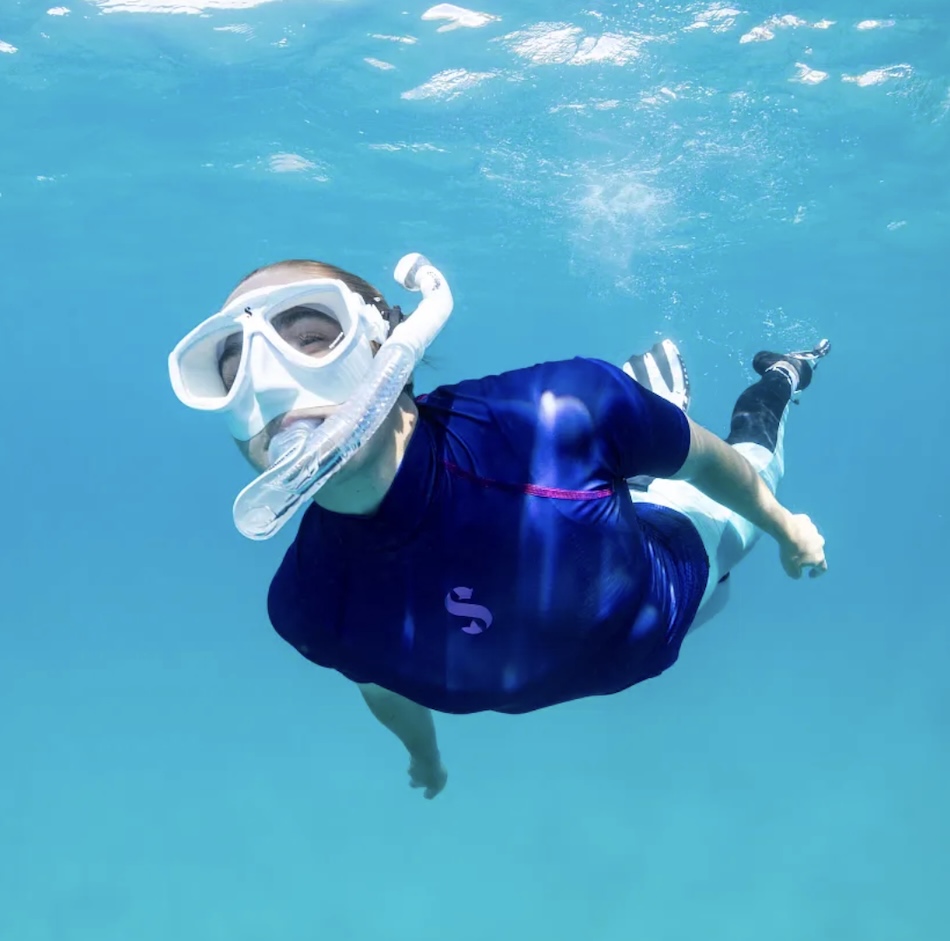 Snorkeling in crystal-clear waters, exploring the beauty of the underwater world.