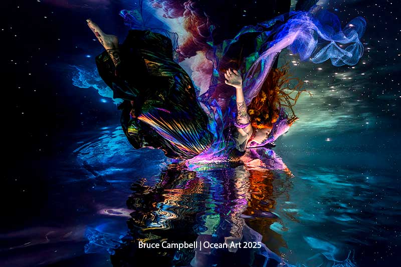 An underwater dancer gracefully moves in luminescent waters, capturing the essence of oceanic art.