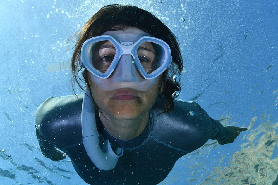 Scuba diving with mask, exploring the beauty of the seabed and aquatic life.