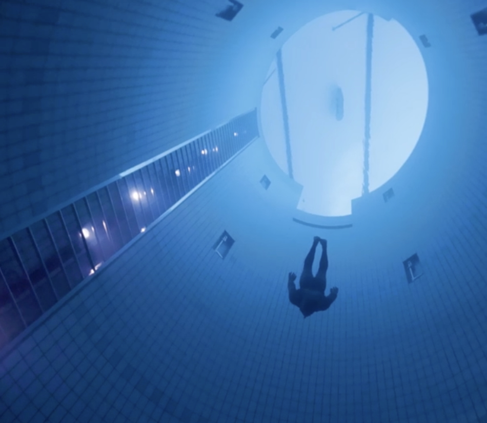 A diver explores the depths of an underwater pool, revealing the fascinating aquatic universe.