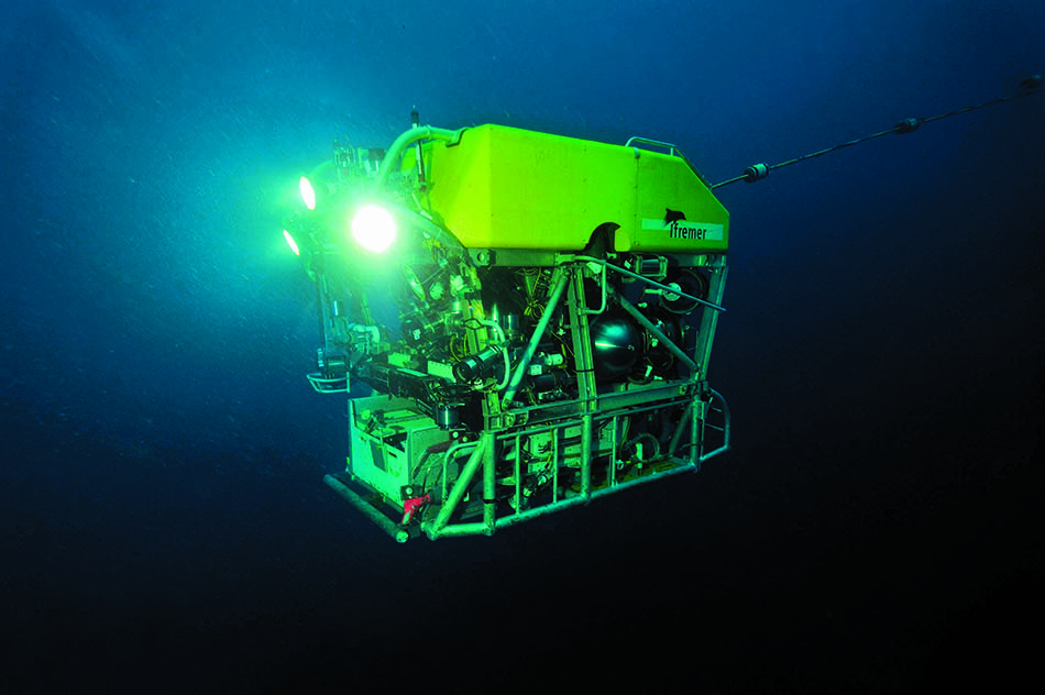 Underwater vehicle exploring the ocean depths with powerful lights for diving.
