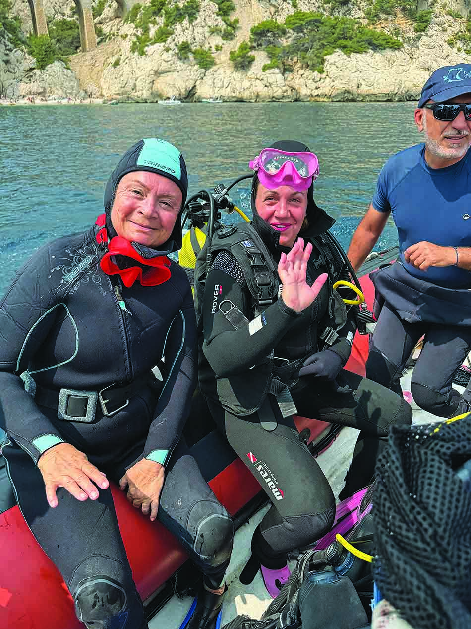 Smiling divers prepare to explore underwater wonders in the Mediterranean.