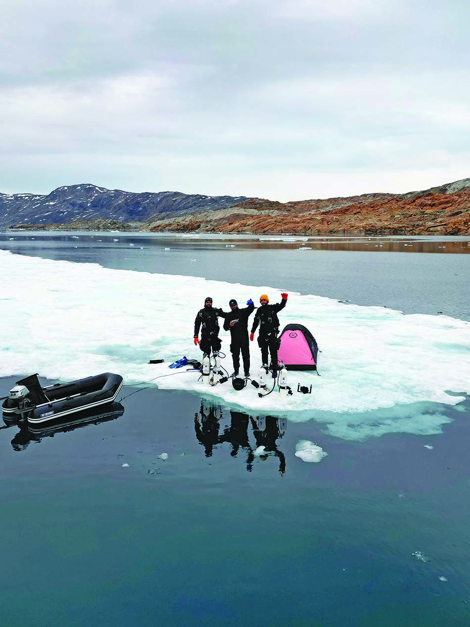 Scuba diving in icy waters, exploring the beauty of Arctic landscapes.